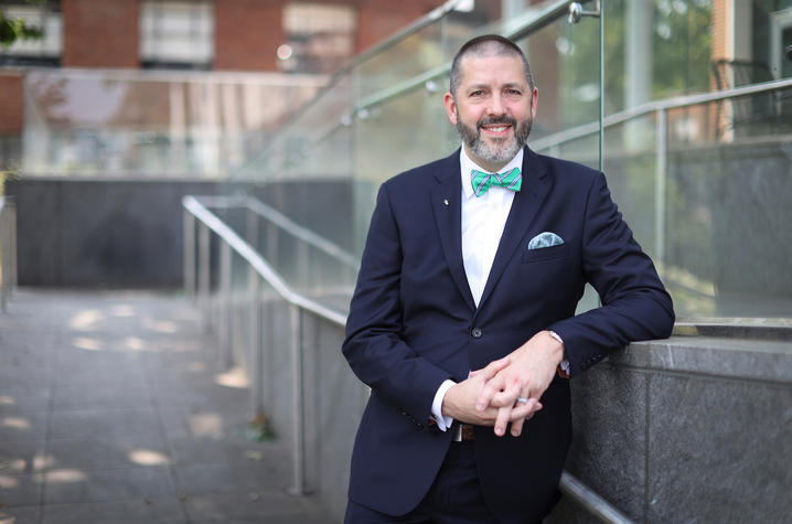 Matthew Bush posed for a photo while leaning on a railing.